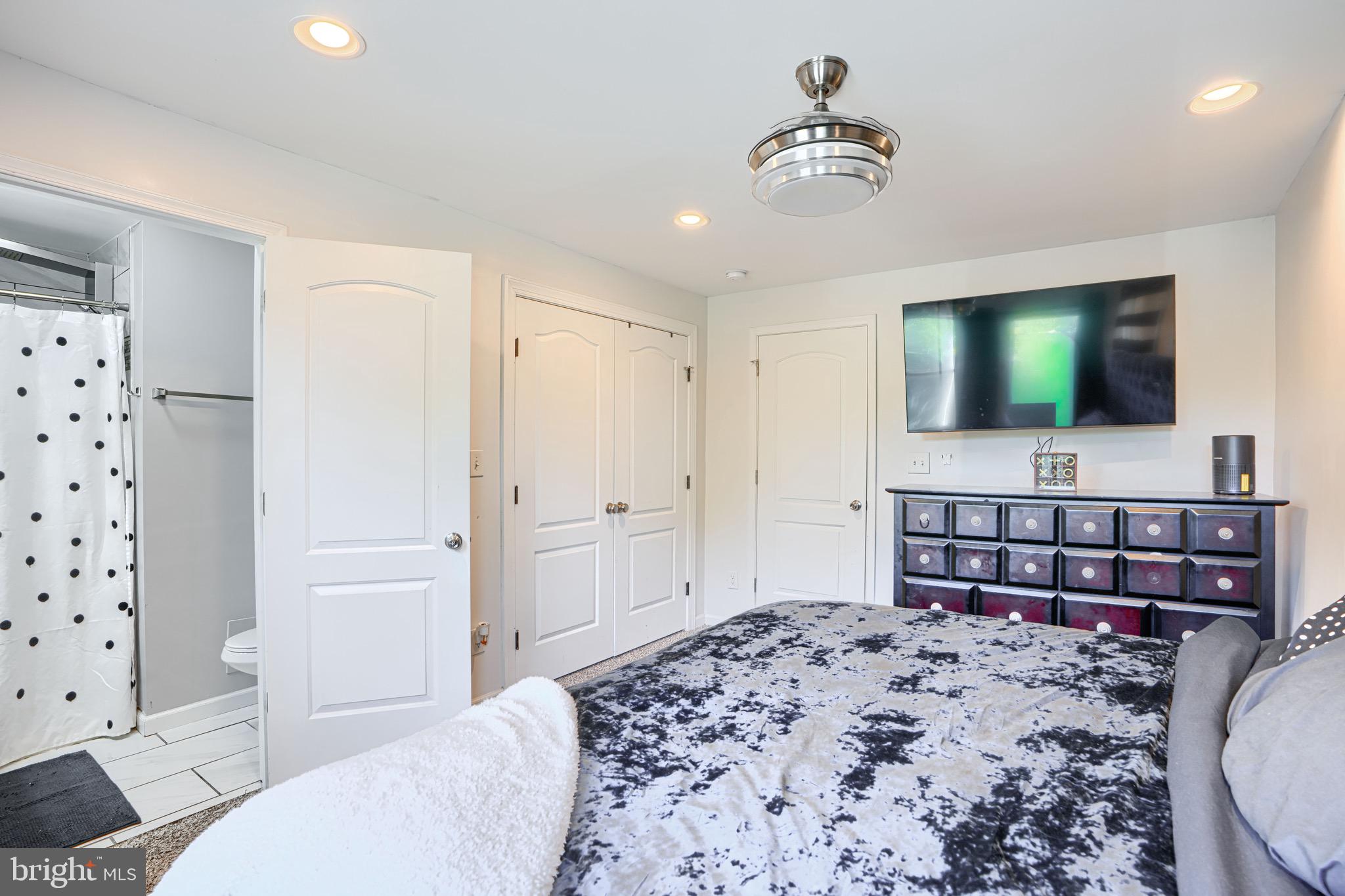 4054 Hilton Road Baltimore, MD 21215 - Photo 10 of 26 a bedroom with a bed and a flat screen tv