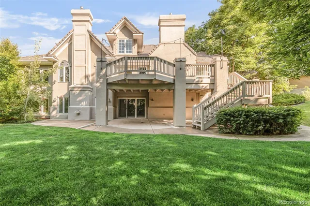 front view of a brick house with a large trees
