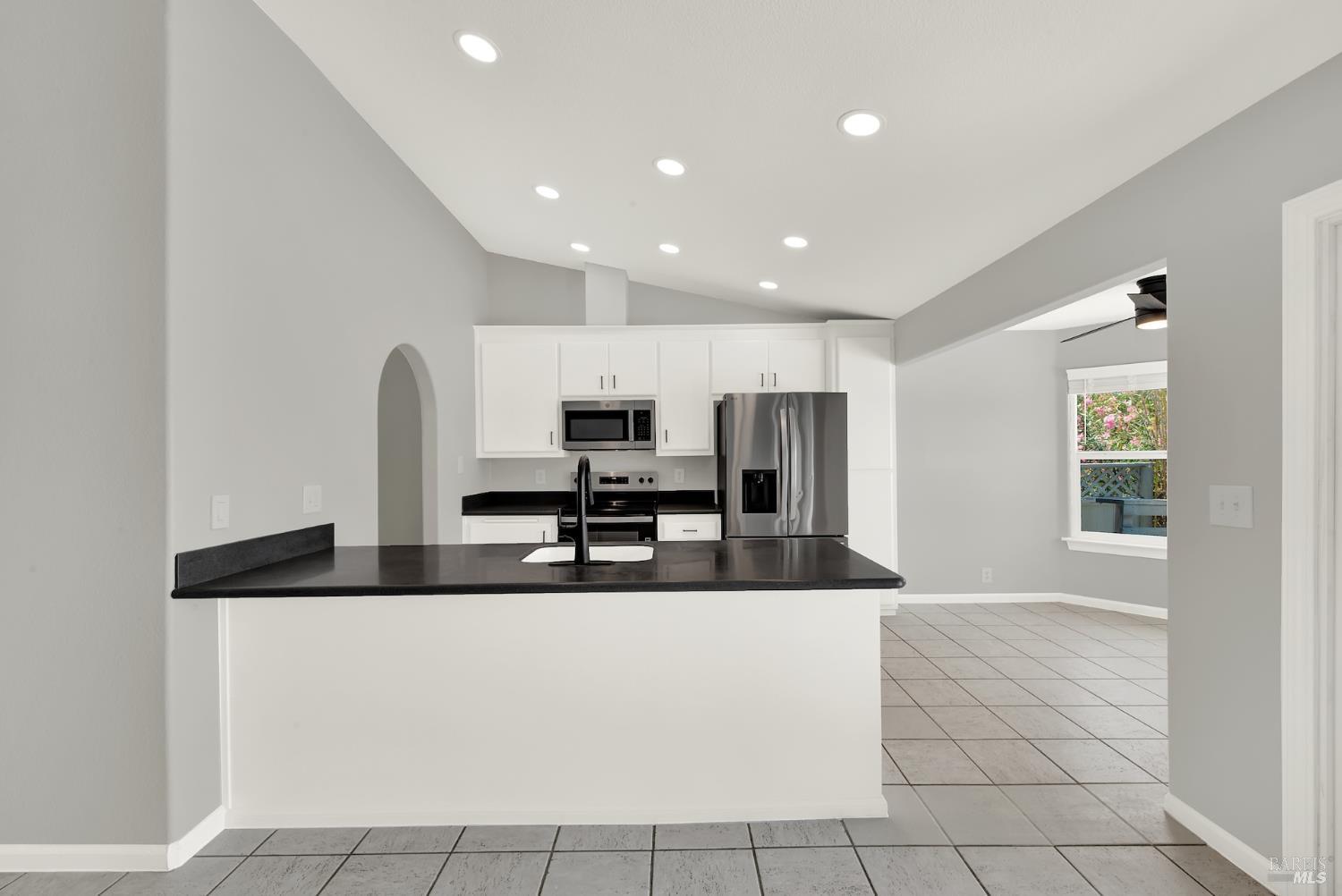 1270 Willow Lake Road Discovery Bay, CA 94505 - Photo 11 of 29 a large kitchen with stainless steel appliances a sink a stove a microwave a counter top space and cabinets