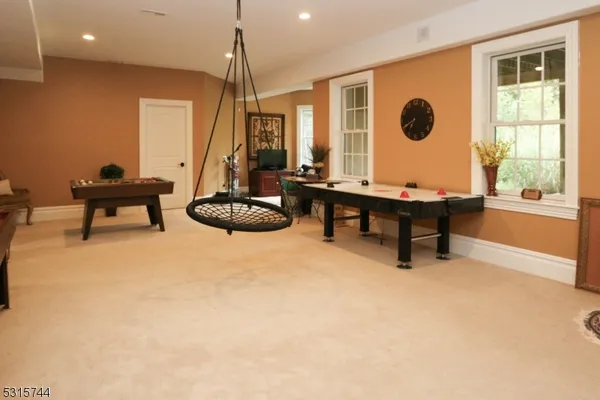 a living room with furniture a rug and a large window