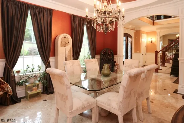 a dining room with fireplace furniture and a chandelier