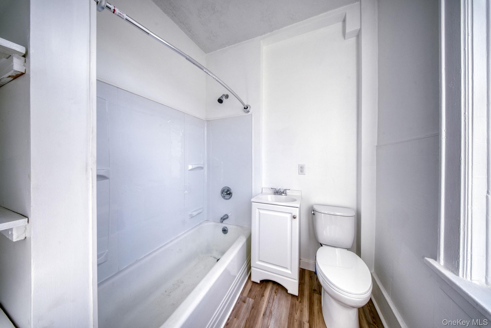 9 Mongaup Road Hurleyville, NY 12747 - Photo 18 of 35 Full bathroom featuring wood finished floors, shower / bath combination, and vanity