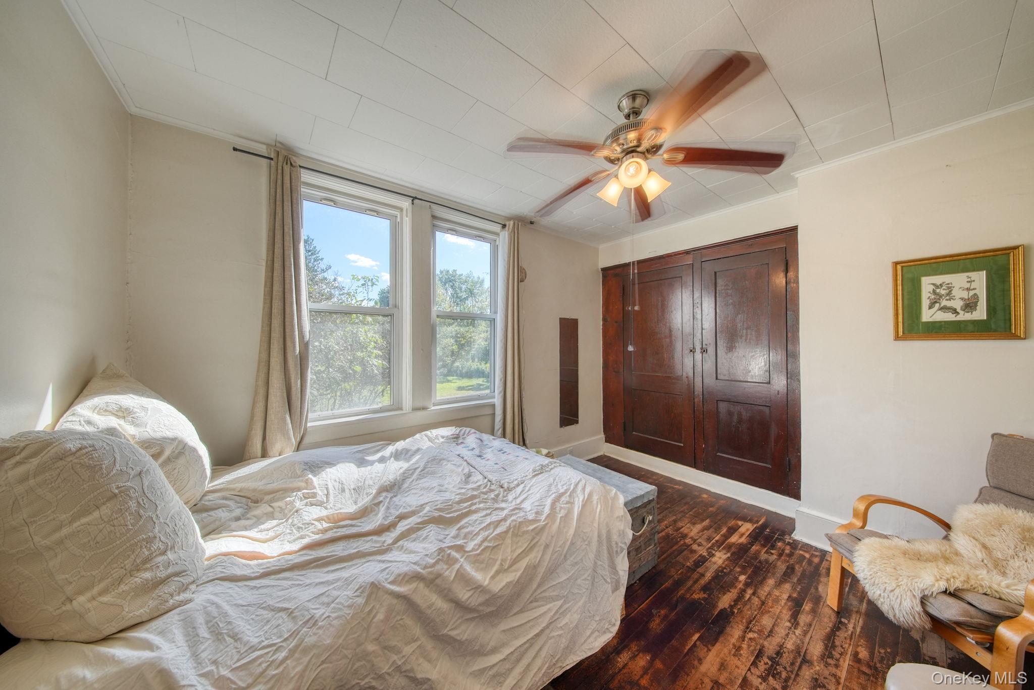 9 Mongaup Road Hurleyville, NY 12747 - Photo 22 of 35 Bedroom with dark wood-style flooring, a ceiling fan, and ornamental molding