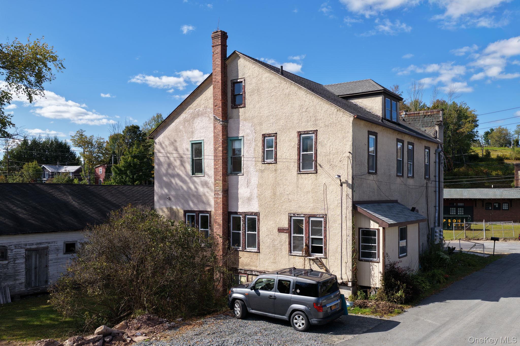 9 Mongaup Road Hurleyville, NY 12747 - Photo 3 of 35 View of home's exterior with stucco siding and a chimney