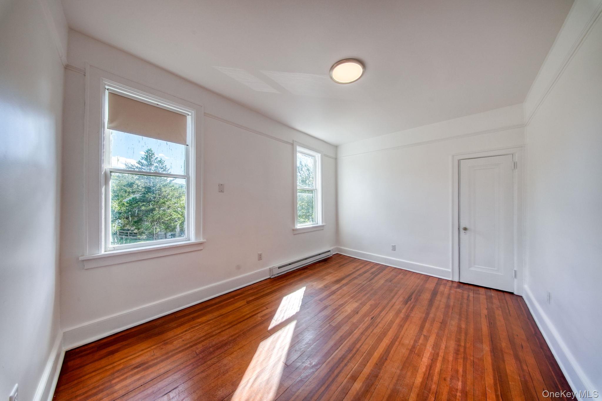 9 Mongaup Road Hurleyville, NY 12747 - Photo 8 of 35 Spare room featuring hardwood / wood-style floors and a baseboard heating unit
