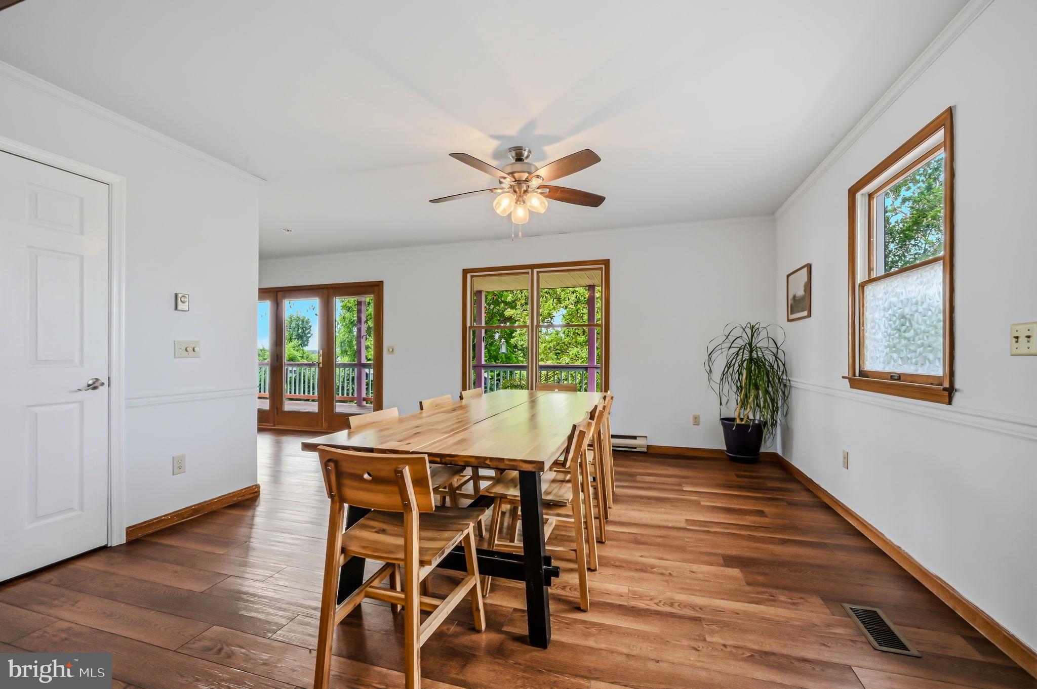 210 Elk View Road North East, MD 21901 - Photo 10 of 64 a dining room with furniture a window and wooden floor