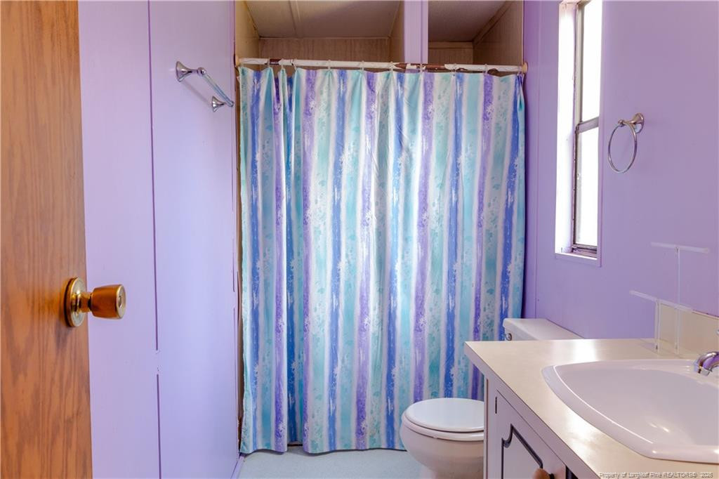 231 Knight Lane Autryville, NC 28318 - Photo 25 of 27 a bathroom with a sink toilet and shower