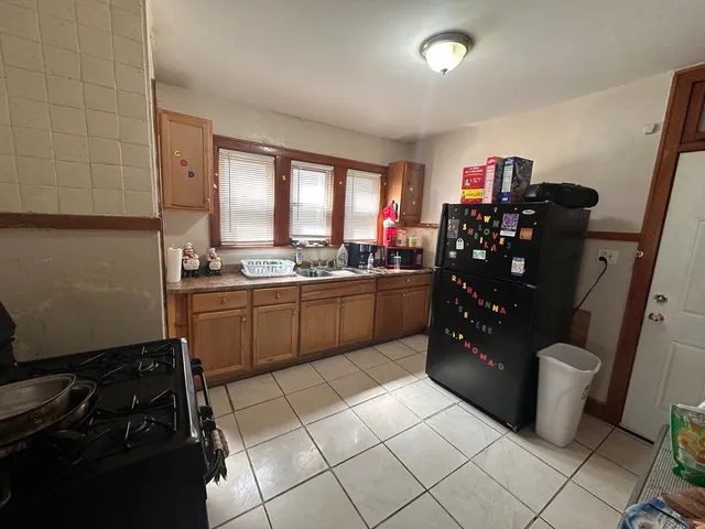 a kitchen with granite countertop a refrigerator and a stove