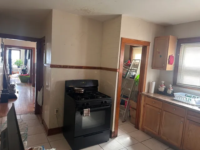 a kitchen with a refrigerator and a stove