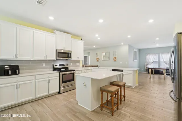 a kitchen with stainless steel appliances a refrigerator and a stove
