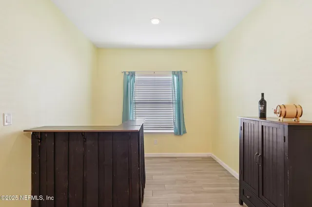 a spacious bedroom with a bed a chandelier and closet
