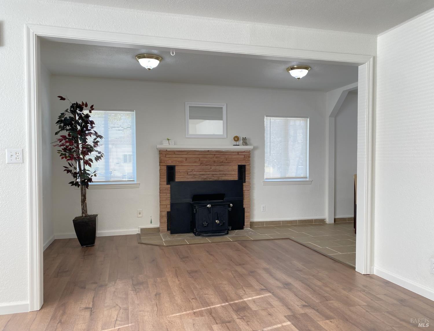 1047 Ohio Street Fairfield, CA 94533 - Photo 14 of 36 a view of an empty room with a fireplace and a window