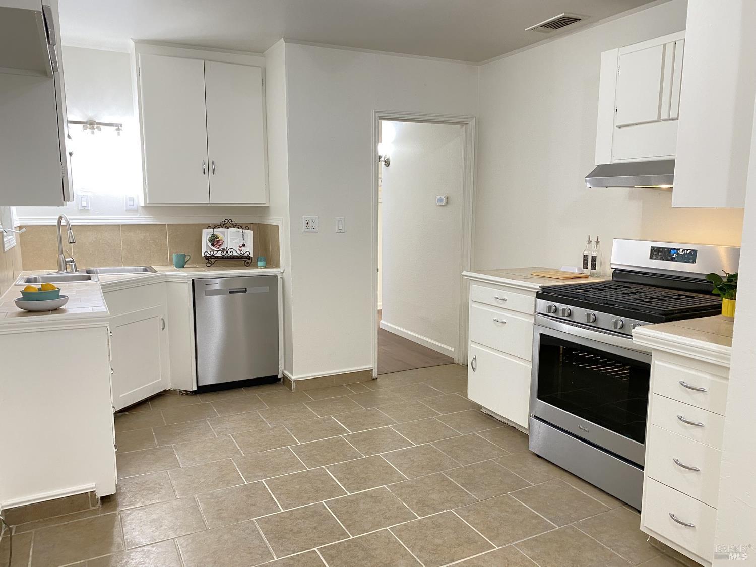 1047 Ohio Street Fairfield, CA 94533 - Photo 16 of 36 a kitchen with cabinets stainless steel appliances and a counter space