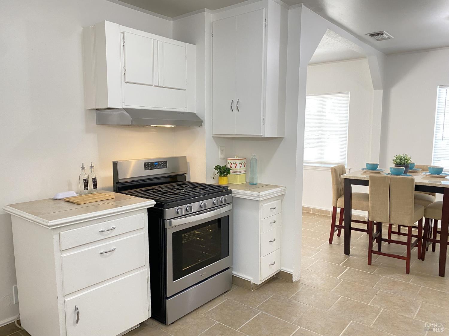 1047 Ohio Street Fairfield, CA 94533 - Photo 17 of 36 a kitchen with a stove and white cabinets