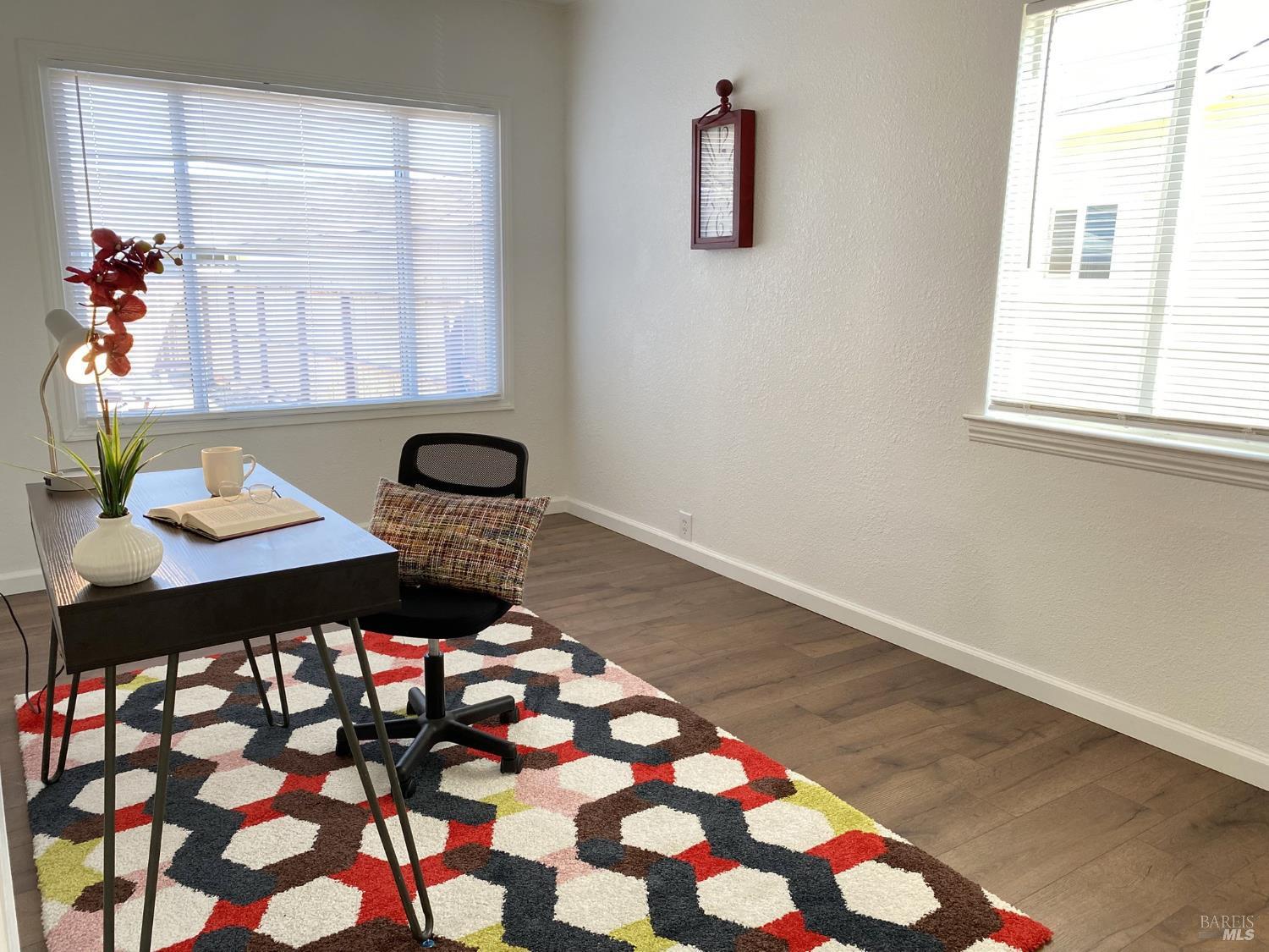 1047 Ohio Street Fairfield, CA 94533 - Photo 26 of 36 a living room with a black white checkered floor with a dining table and chair