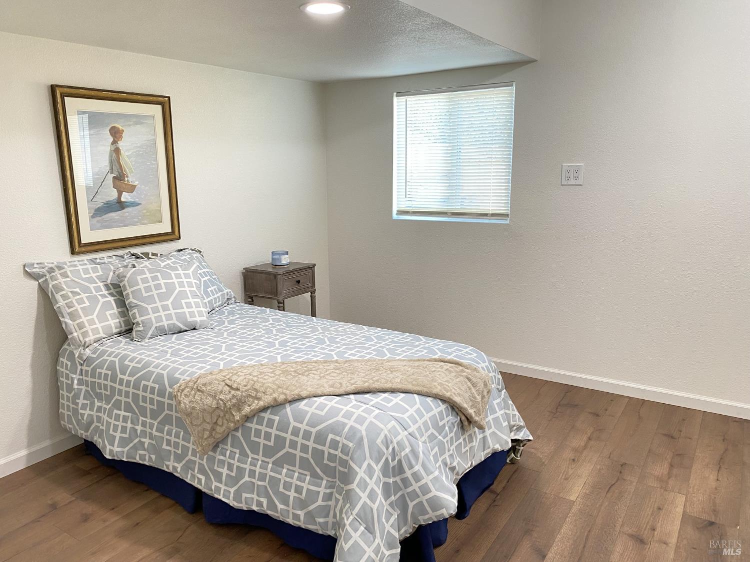 1047 Ohio Street Fairfield, CA 94533 - Photo 32 of 36 a bedroom with a bed and wooden floor