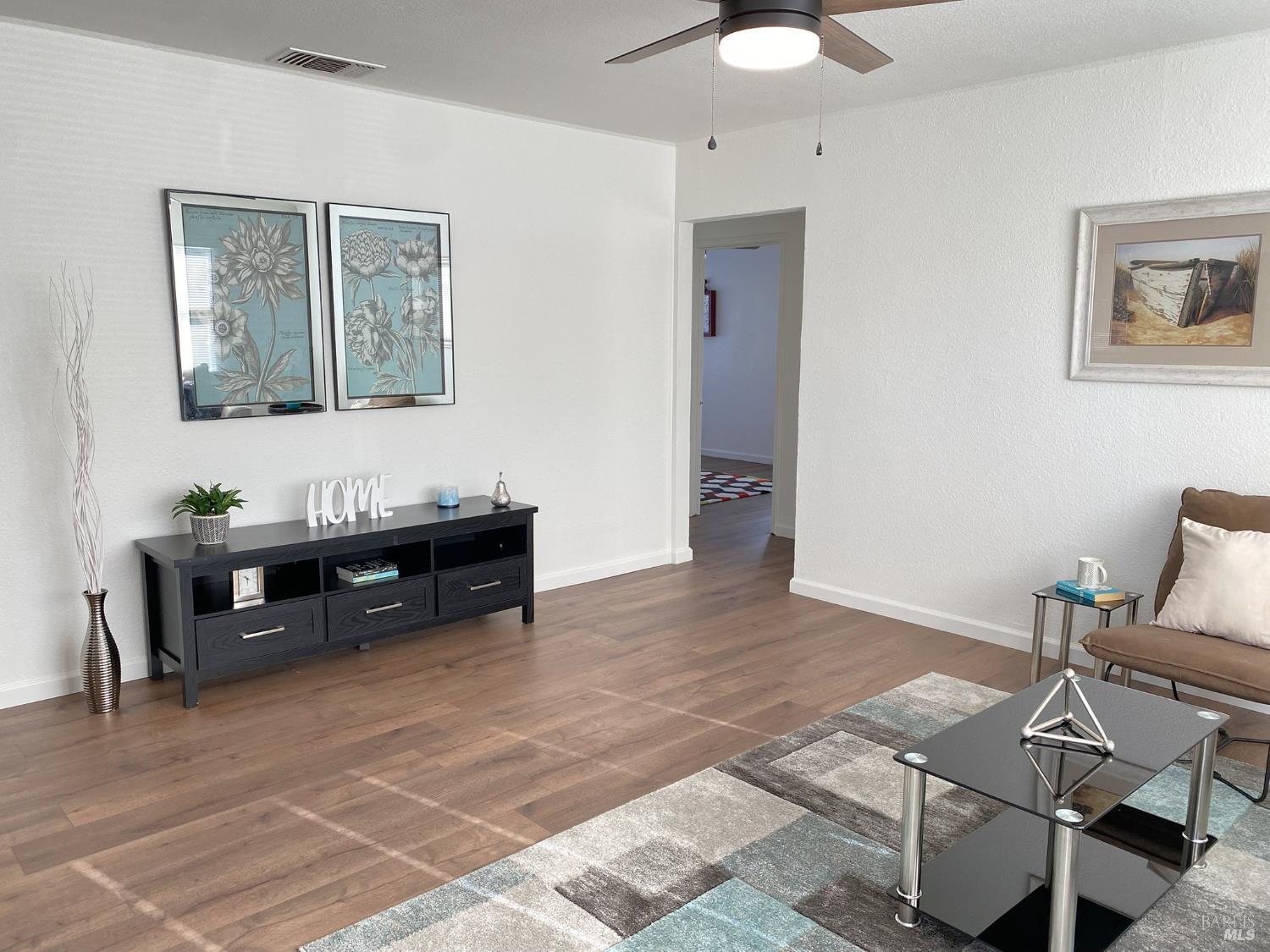 1047 Ohio Street Fairfield, CA 94533 - Photo 9 of 36 a living room with furniture and wooden floor