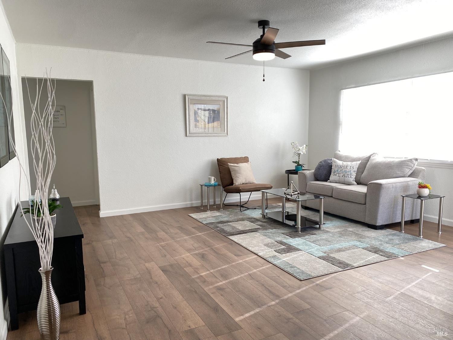 1047 Ohio Street Fairfield, CA 94533 - Photo 10 of 36 a living room with furniture and a flat screen tv