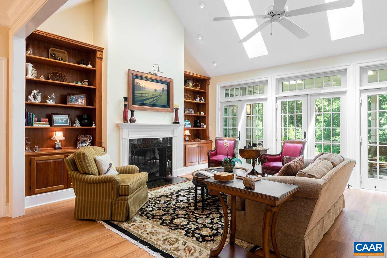 2274 Garth Road Charlottesville, VA 22901 - Photo 11 of 32 a living room with furniture a fireplace and a floor to ceiling window