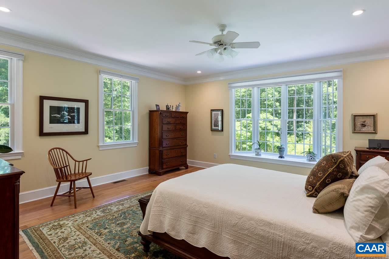 2274 Garth Road Charlottesville, VA 22901 - Photo 14 of 32 a bedroom with a bed a chair and a large window