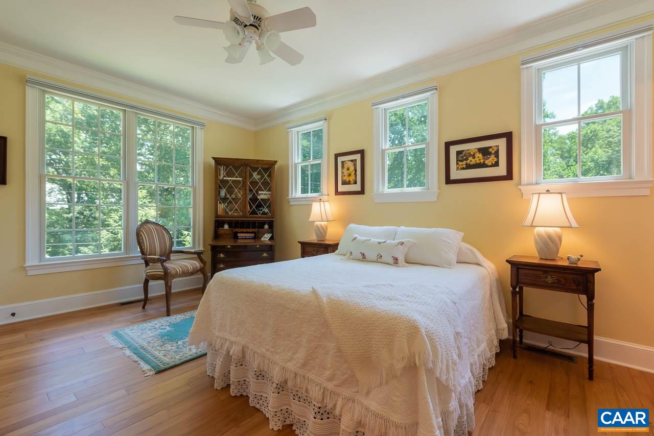 2274 Garth Road Charlottesville, VA 22901 - Photo 16 of 32 a bedroom with a bed and a table