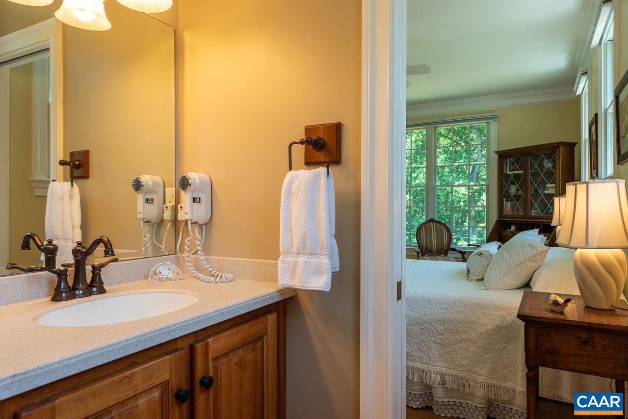 2274 Garth Road Charlottesville, VA 22901 - Photo 17 of 32 a bathroom with a double vanity sink and a mirror