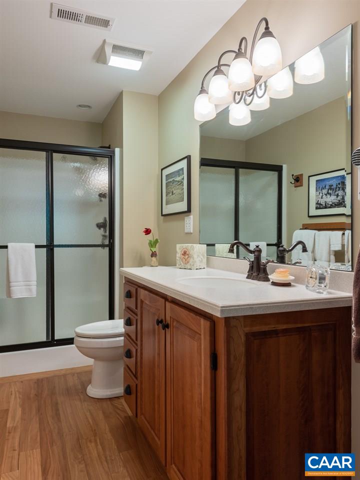 2274 Garth Road Charlottesville, VA 22901 - Photo 24 of 32 a bathroom with a sink a toilet and a mirror