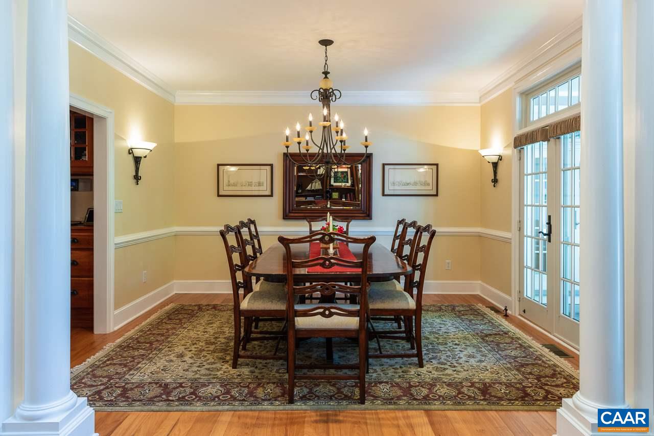 2274 Garth Road Charlottesville, VA 22901 - Photo 5 of 32 a dining room with furniture a rug and a chandelier