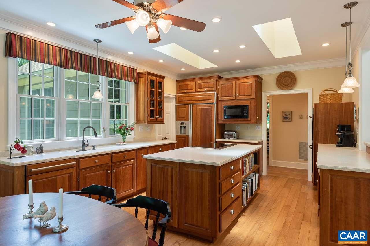 2274 Garth Road Charlottesville, VA 22901 - Photo 7 of 32 a kitchen with a stove a sink and a refrigerator