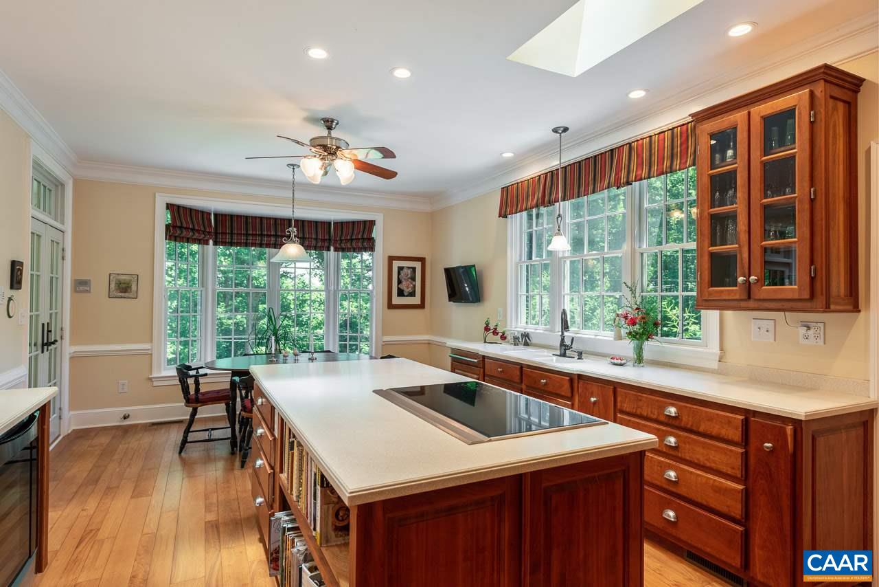 2274 Garth Road Charlottesville, VA 22901 - Photo 8 of 32 a kitchen with a stove a sink dishwasher and a dining table with garden view
