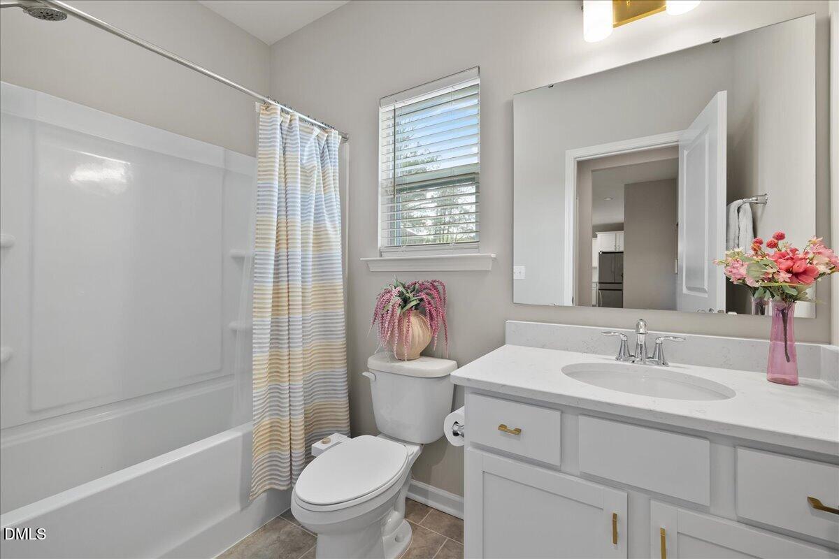 1237 Huffington Oak Drive Willow Spring, NC 27592 - Photo 15 of 34 a bathroom with a sink toilet and shower