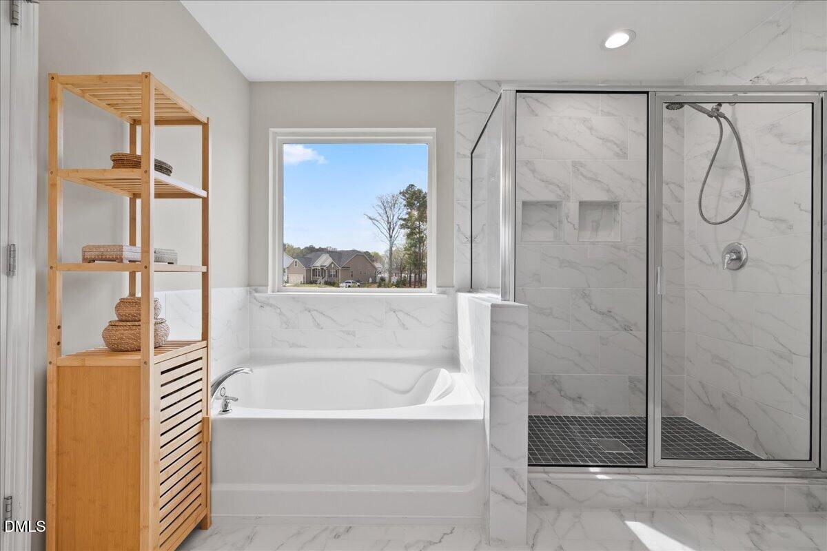 1237 Huffington Oak Drive Willow Spring, NC 27592 - Photo 20 of 34 a bathroom with a glass shower door