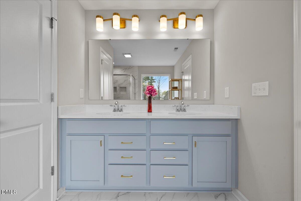 1237 Huffington Oak Drive Willow Spring, NC 27592 - Photo 21 of 34 a bathroom with a sink vanity and a mirror
