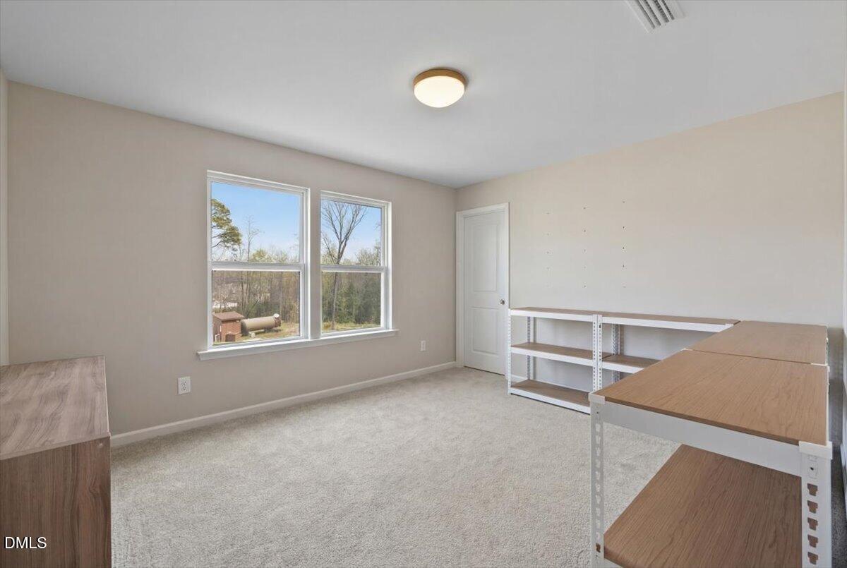 1237 Huffington Oak Drive Willow Spring, NC 27592 - Photo 25 of 34 a view of an empty room with a window