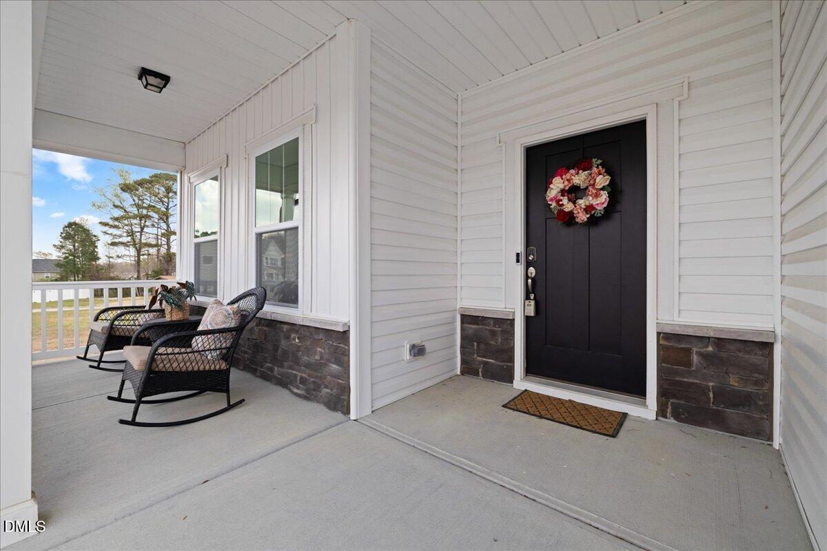 1237 Huffington Oak Drive Willow Spring, NC 27592 - Photo 4 of 34 a living room with furniture a front door and a window