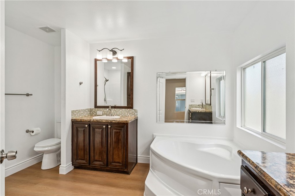 10550 Dunlap Crossing Road, Unit 141 Whittier, CA 90606 - Photo 22 of 38 a spacious bathroom with a granite countertop sink and a mirror