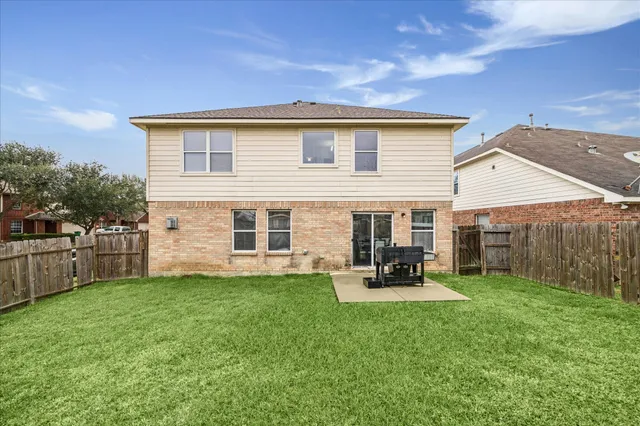 a view of a house with a yard and sitting area