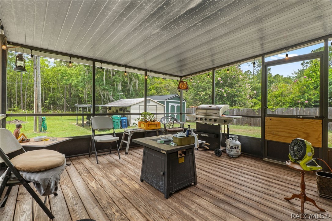 7927 West Cyprian Court Homosassa, FL 34448 - Photo 31 of 40 a view of a patio with lawn chairs and wooden floor