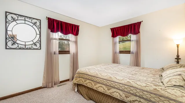 a bedroom with a bed and a mirror