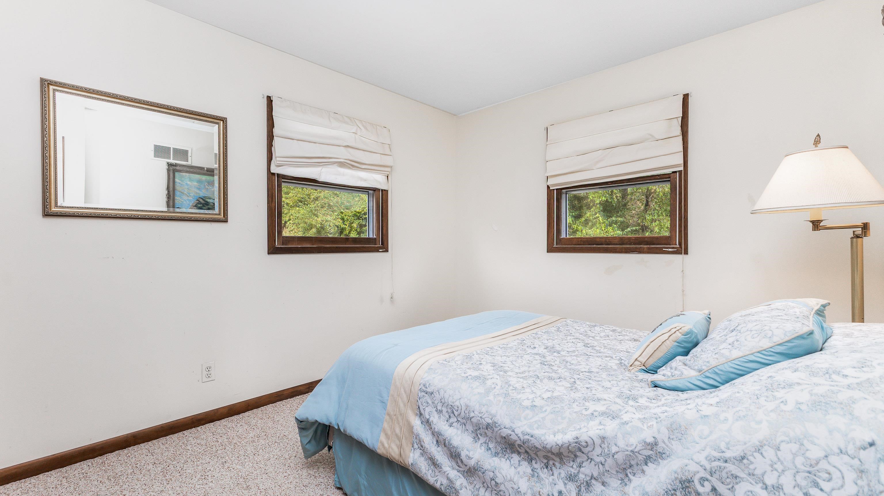 6 Meadow Path Galena, IL 61036 - Photo 19 of 29 a bedroom with a bed and a painting on the wall