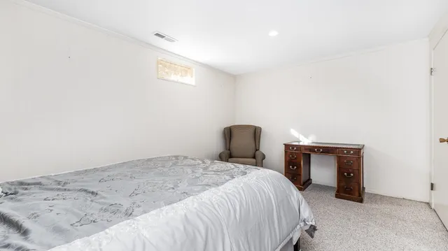 a bedroom with a bed and a fireplace