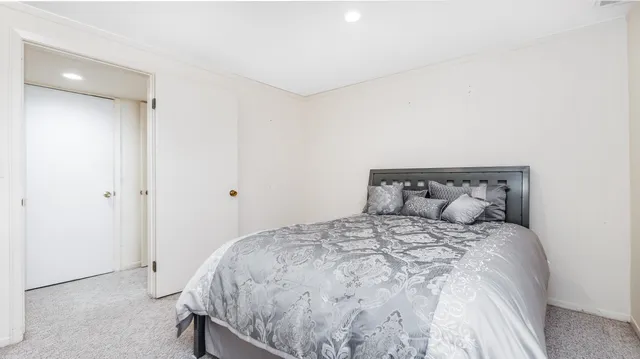 a large bed sitting in a bedroom next to a cabinet