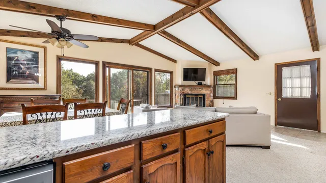 a kitchen with granite countertop a sink and a refrigerator