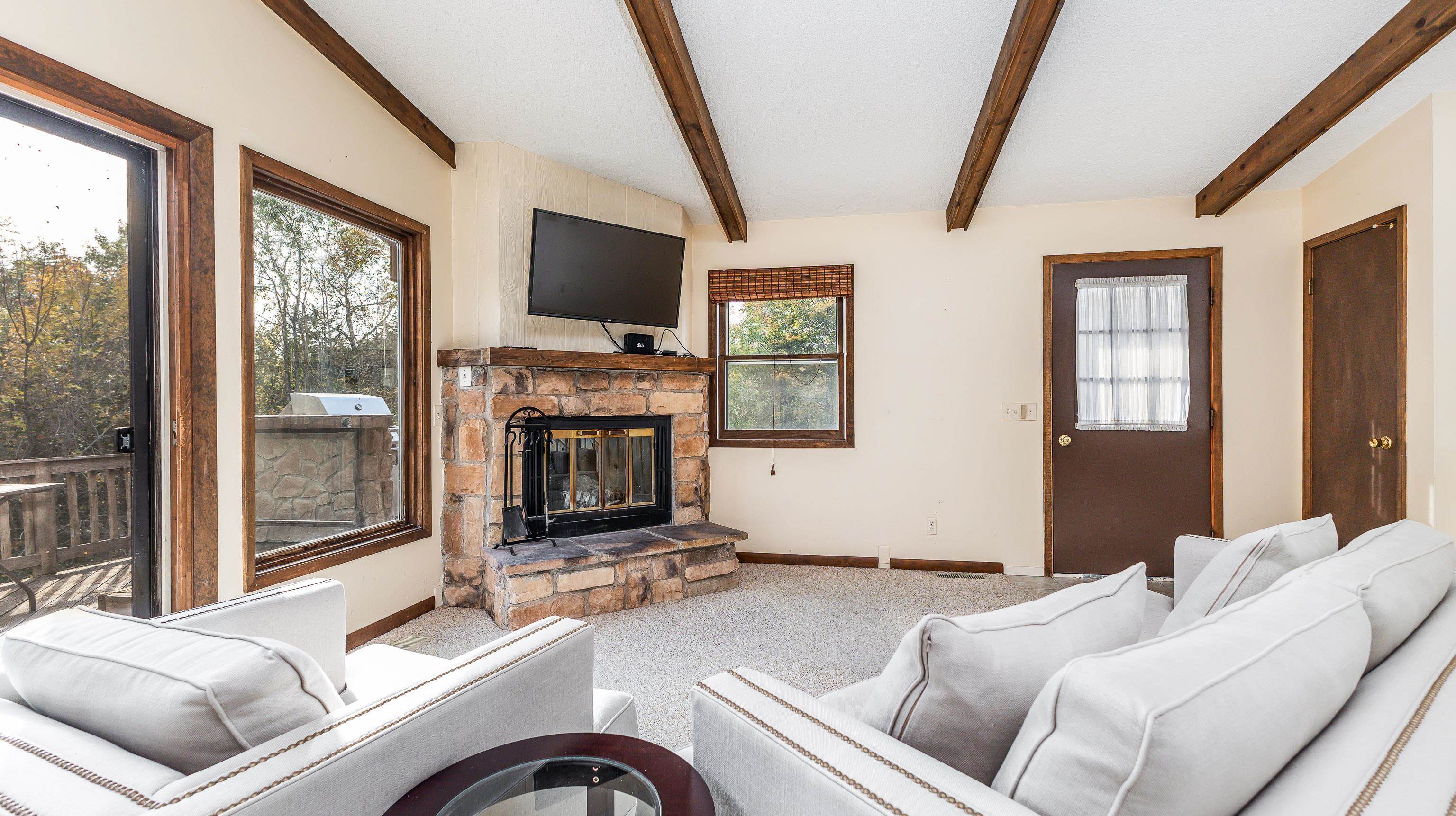 6 Meadow Path Galena, IL 61036 - Photo 10 of 29 a living room with furniture a flat screen tv and a fireplace