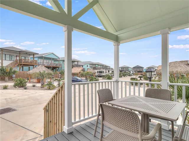 a view of a balcony dining table and chairs