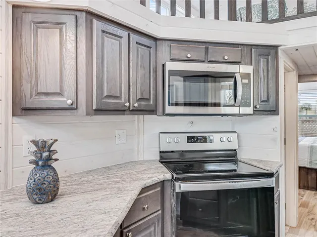 a kitchen with granite countertop a stove sink and cabinets