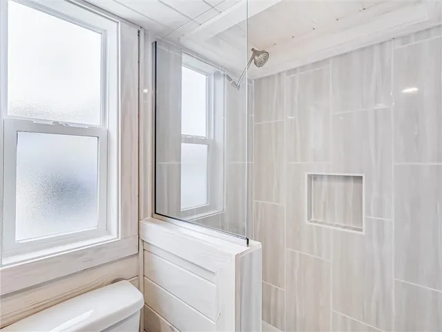a bathroom with a shower and a window