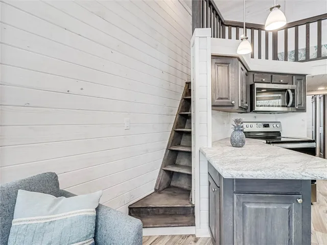 a view of kitchen with sink microwave and refrigerator