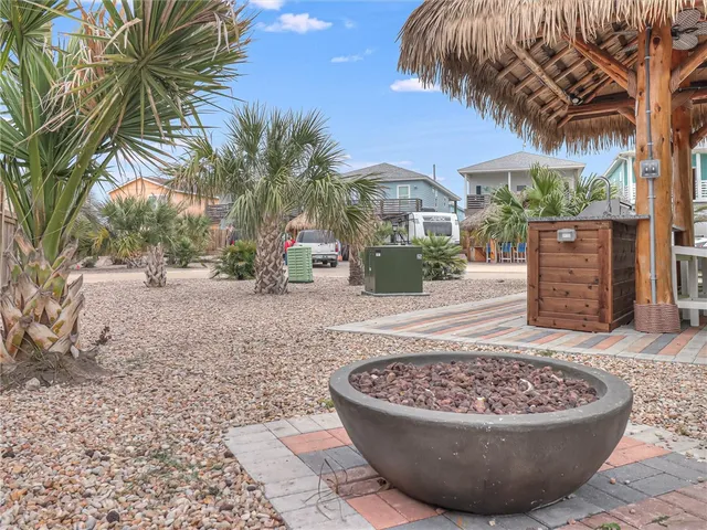 a view of a house with a swimming pool and sitting area