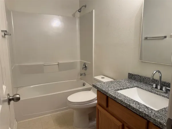 a white toilet sitting next to a white sink